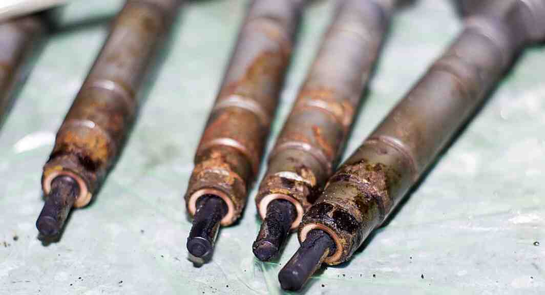 Four removed injectors with coked tips
