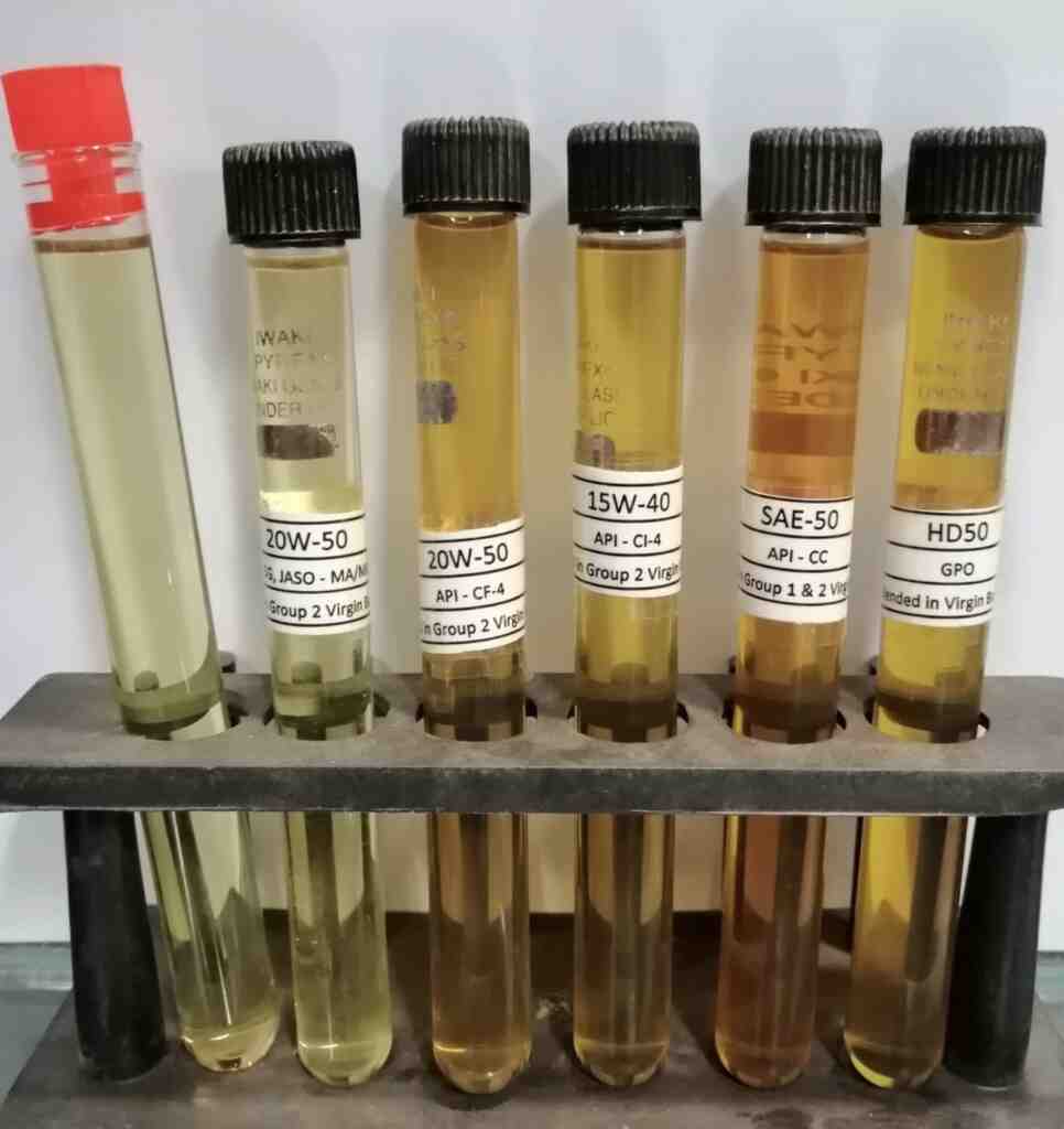Engine oil samples in test tubes showing different degrees of oxidation