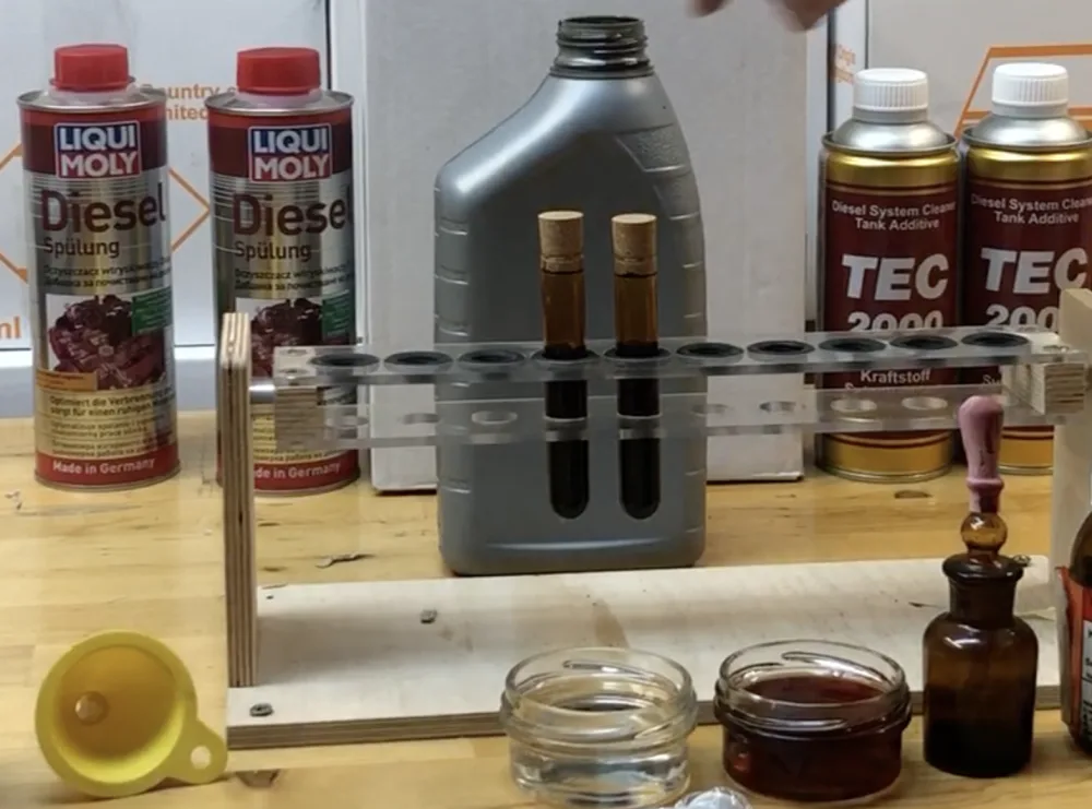 Comparison of TEC 2000 Diesel System Cleaner and Liqui Moly Diesel Spülung in test tubes on a workshop bench